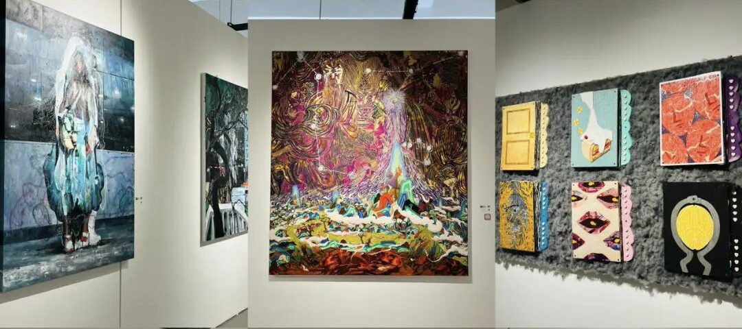 Gallery exhibition wall with colorful original paintings and artworks on display