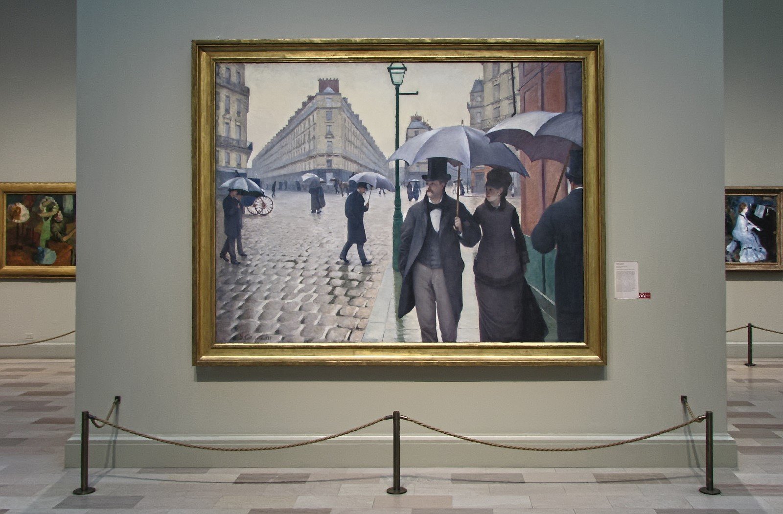 Hand-painted oil reproduction of Paris Street; Rainy Day, Caillebotte couple under an umbrella crossing wet cobblestones before new Haussmann buildings